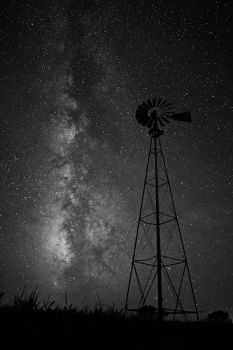 The summer Milky Way with a lone prairie windmill in a corn field of rural Brule County.
