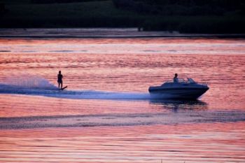 Waterskiing at sunset.
