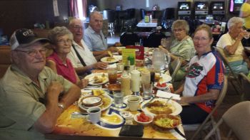 Carl and Jan enjoy spaghetti dinner with Charlie Eich (seated at the far end of the table) and other local seniors.