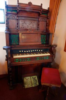 An old and ornate pump organ found at the back of the sanctuary.