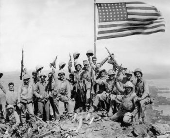 Mitchell native Jack Thurman is shown at the far left, waving his cap, in Joe Rosenthal's famous World War II photograph. Click to enlarge photo.
