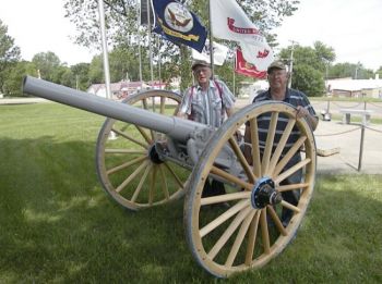 Jim Tapken and Walter Borkowski, members of Willman-Fee Post #14 of the American Legion, stand next to the newly-restored cannon. Photo by Duke Wenzel, <i>True Dakotan</i>.