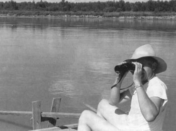Tom Kilian takes a moment to get a closer look at the scenery along the Missouri through his binoculars.