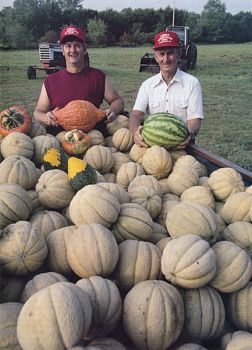 Skip and Levo Larson with a fresh crop of melons and gourds.