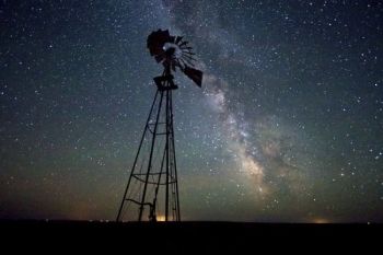 The Milky Way provides a starry background.