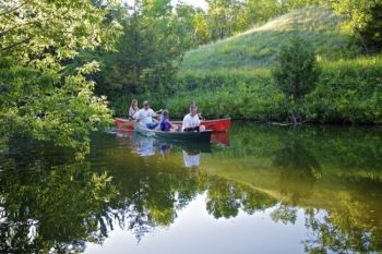 The Begemans paddle up the creek channel.