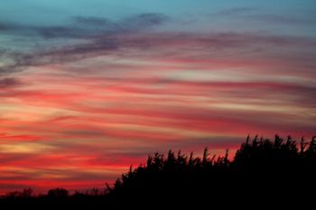 Higher elevation clouds reflect beautiful hues nearly a half hour after the sun set at Lake Alvin.