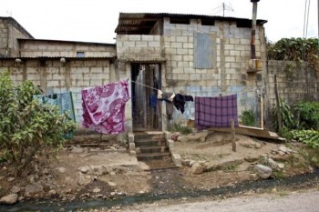 The day’s wash brings color to this village scene.  Running water is a blessing, however no sewer system means the likelihood of sickness and disease.