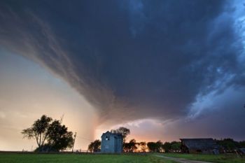 Storm clouds over an abandoned house between Spencer and Salem, South Dakota.