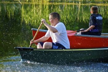 Trevor Begeman gets a playful splash from dad's paddle.