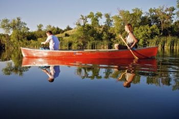 DeDee and Trevor Begeman are mirrored in Lake Hiddenwood's peaceful waters.