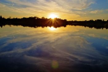 Still waters mirror the setting sun. Click to enlarge photos.