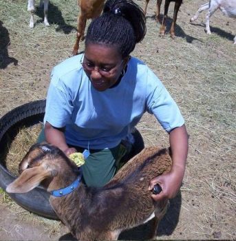 Mills and one of the goats on her Box Elder farm.