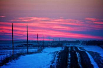 The sun's fading rays paint the western horizon pink and purple.