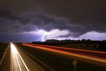 A storm approaches on I-90 just west of Sioux Falls. A well-lit semi going west provided the color streaking in the foreground.