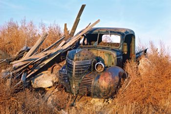 THE HOMESTEAD. South of Harrold I saw this rare Plymouth pickup. The owners had torn down the buildings and shoved everything on a pile. It looked like they’d placed the Plymouth carefully on top.