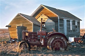 OTTO’S TRACTOR. This was my friend Otto’s tractor. Each time when I came home we’d go for a drive. It was loud but it was a thrill at night. In 2007 Otto died the day after I came home. I got to say goodbye to him. The tractor is an International and sits by a country school that he and his wife used as the house on their farm.