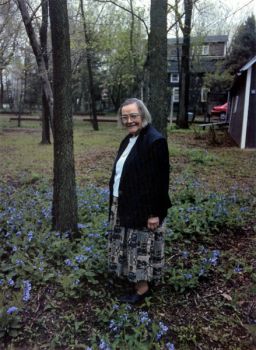 Mary Adams among flowers likely planted by her late sister Maud.