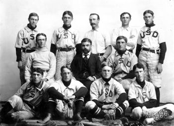 Professor Alexander Pell sits with members of the USD baseball team about 1900.