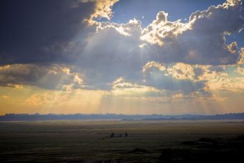 The late afternoon sun breaking through the clearing storm near the Pinnacles area.