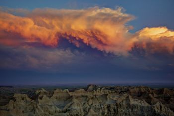 The last light of the day painting the retreating storm clouds.