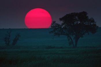 A hazy day makes for a unique sunset on the horizon above LaCreek National Wildlife Refuge.