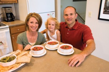 The Schumacher family of Sioux Falls enjoying a traditional family favorite together at their dinner table. Photo by Bernie Hunhoff.
