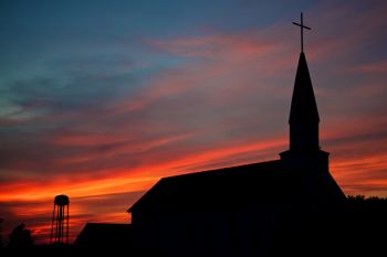 Zion Lutheran and a rural water tower silhouetted against the sunset south of Hartford.