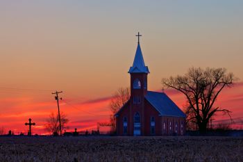 The road curves slightly around Sigel Church, which provides a great view from the east.