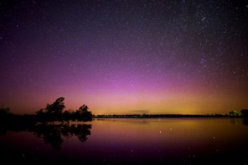 Faint Aurora, a distant shooting star and plenty of stars are reflected in Lake Louise north of Miller in this image taken late last summer.