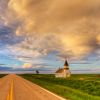 Evening light painted a passing rain cloud above historic Peace Valley Lutheran of northeast Harding County.