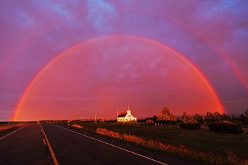 A full rainbow above Slim Buttes Lutheran near Reva.