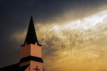 The first bit of evening sunlight illuminated the back of a severe storm in McCook County. Immanuel Lutheran’s steeple is in the foreground.