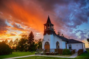 The last bit of rain from a shrinking storm cloud at sunset provided a dramatic sky over River Bend Church (First Presbyterian) just north of Flandreau.