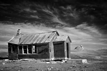 An abandoned schoolhouse with Castle Butte in the distance in Butte County.