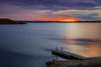 The last light before the clouds and horizon swallow up the sun.
