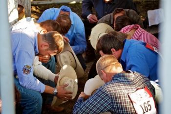 Pre-rodeo prayer time just behind the chutes. These are the bareback riders whose event is the rodeo’s first.