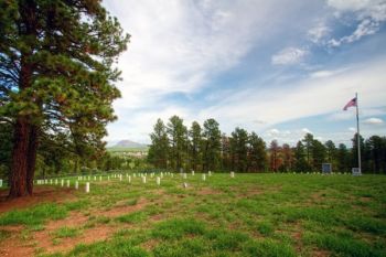 Old Fort Meade Cemetery with a view of the fort itself and Bear Butte through the break in the trees.