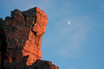 The last light of an October evening colors the face of Queen Rock.