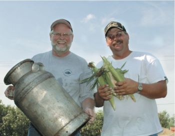 Chefs Larry Wilson, left, and Marty Bigge steam dinners inside vintage cream cans.