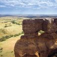 A large column of weathered sandstone frames a view across the plains to the 
east of the Cave Hills where Custer’s Expedition passed about three-quarters of a mile away on July 12, 1874. The Slim Buttes are visible 20 miles off on the distant horizon.