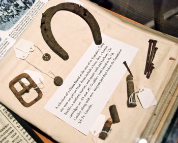The book features artifacts found at Expedition campsites, such as these pieces from the Journey Museum’s collection in Rapid City. Buttons, buckles, cartridges, square nails, and horseshoes are among the items left behind in 1874.