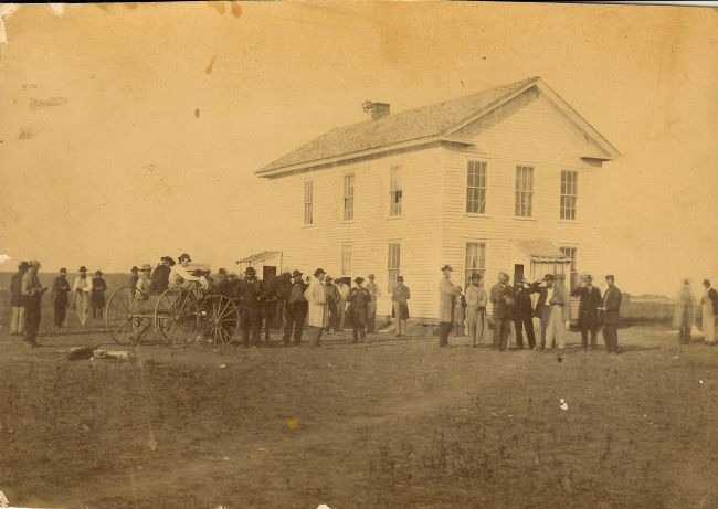 Pioneer politicians and members of the  Yankton gang  gather at the first territorial capitol in downtown Yankton.