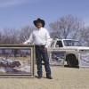 Galen Wallum displays a few of the paintings he pulled out of his pickup trailer.