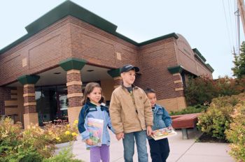 The first library was just a room in the Spearfish Hotel. Today, patrons (including, from left, Nazeli, Baran and Zane Lechner) enjoy a modern downtown building constructed in 1996.