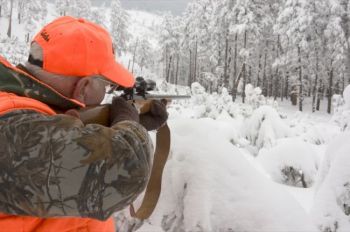 A hunter takes aim in the snowy Black Hills. S.D. Tourism photo.