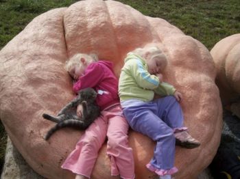 Kevin Marsh's daughters, Maddie and Autumn, nap in one of their father's giant pumpkins. Photo by Kevin Marsh of Parker, SD.