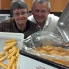 Patti Frazee (one of the kitchen helpers) with krumkake and Al Mathiasen with a roaster of klub. Photo from Kathy Mathiasen.