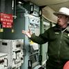 A National Park Service employee points to the double-locked red box that concealed the code and keys for a missile launch at the Minuteman Missile National Historic Site. 2007 photo by Paul Higbee.