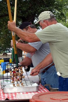 Removing the meat from the hot forks.